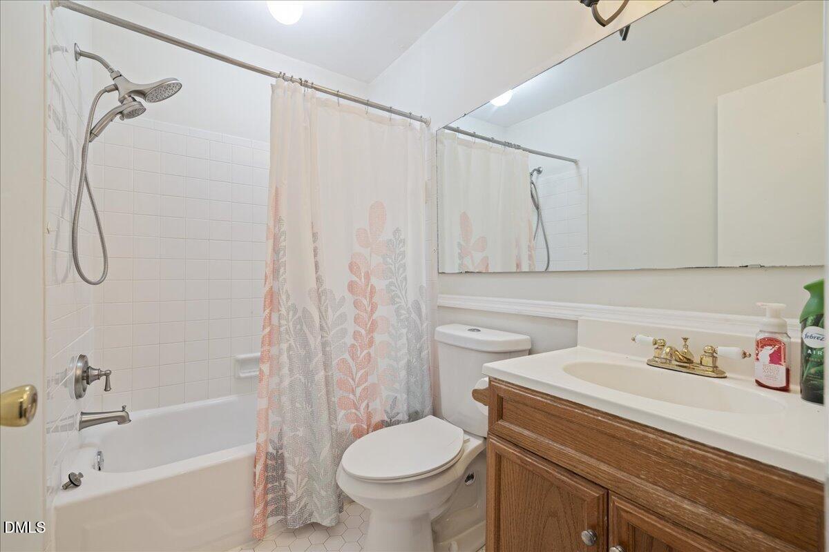 1738 Quail Ridge Road Raleigh, NC 27609 - Photo 32 of 38 a bathroom with a sink toilet and shower