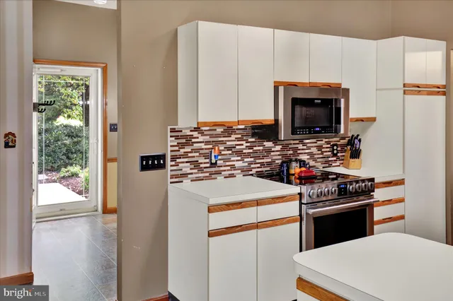 a kitchen with a stove a sink and a refrigerator
