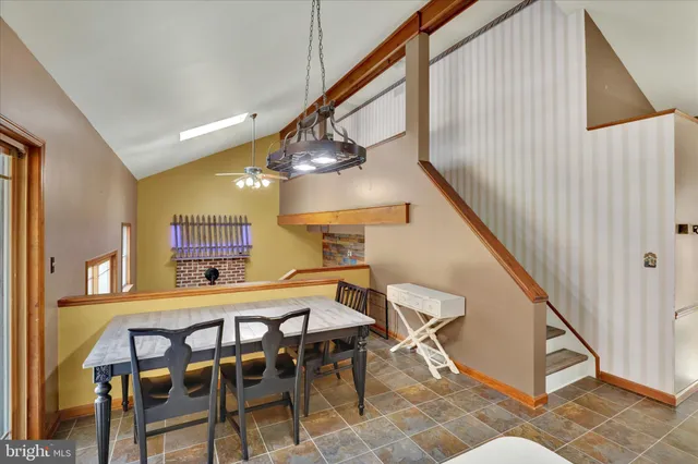 a dining room with furniture and a wooden floor