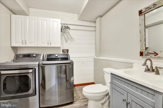 a bathroom with a sink a toilet and a mirror