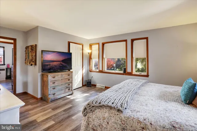 a bedroom with a bed and a flat screen tv