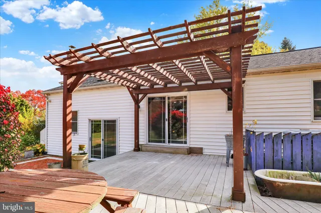 a view of a house with wooden floor and a barbeque