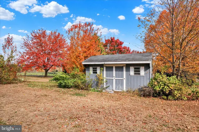 a front view of a house with a yard and potted plants