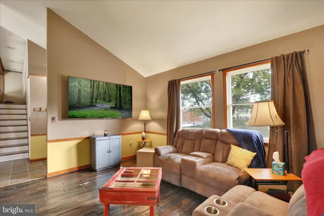 a living room with furniture and a flat screen tv