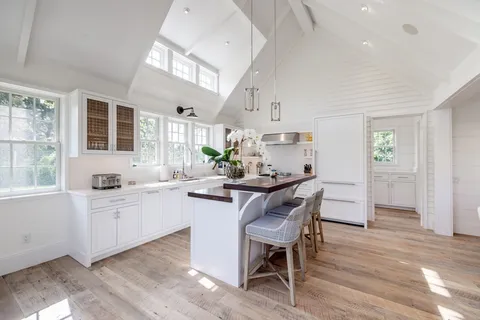 a living room with furniture a table and chairs