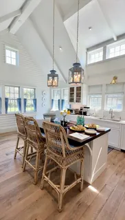 a dining room with furniture and wooden floor
