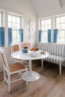 a table with a vase and flowers on it