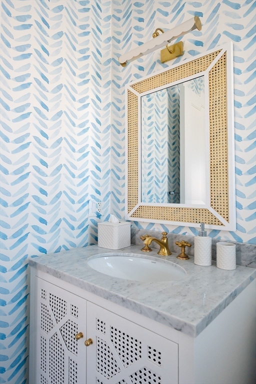 106 A Surfside Road, Unit EAST Nantucket, MA 02554 - Photo 29 of 42 a bathroom with a granite countertop sink and a mirror