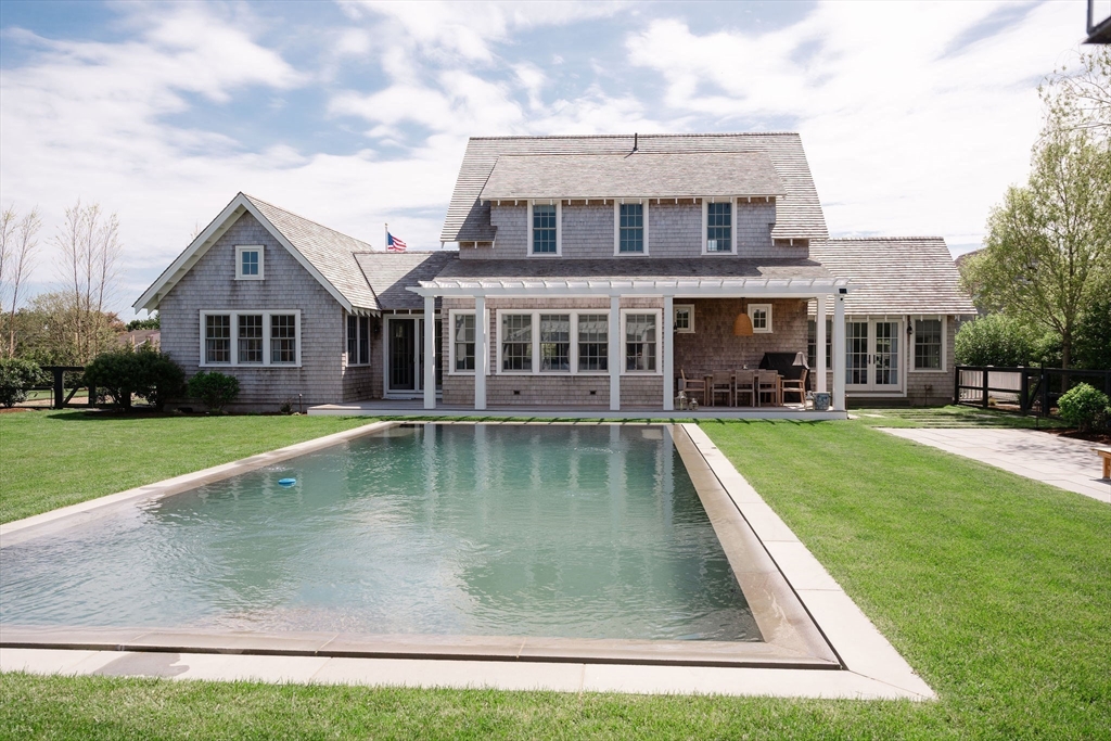 106 A Surfside Road, Unit EAST Nantucket, MA 02554 - Photo 3 of 42 a view of a house with a swimming pool