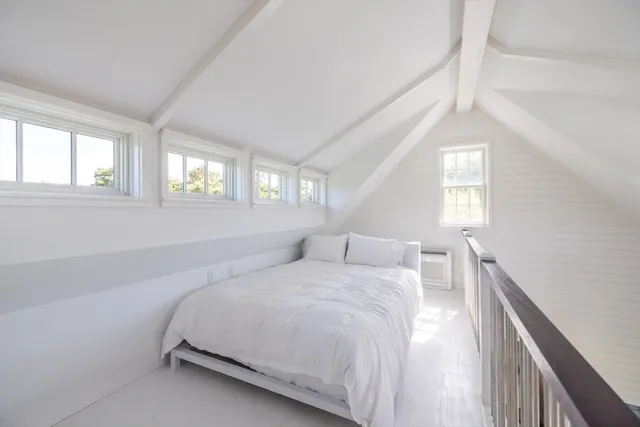 a front view of house with yard and lake view