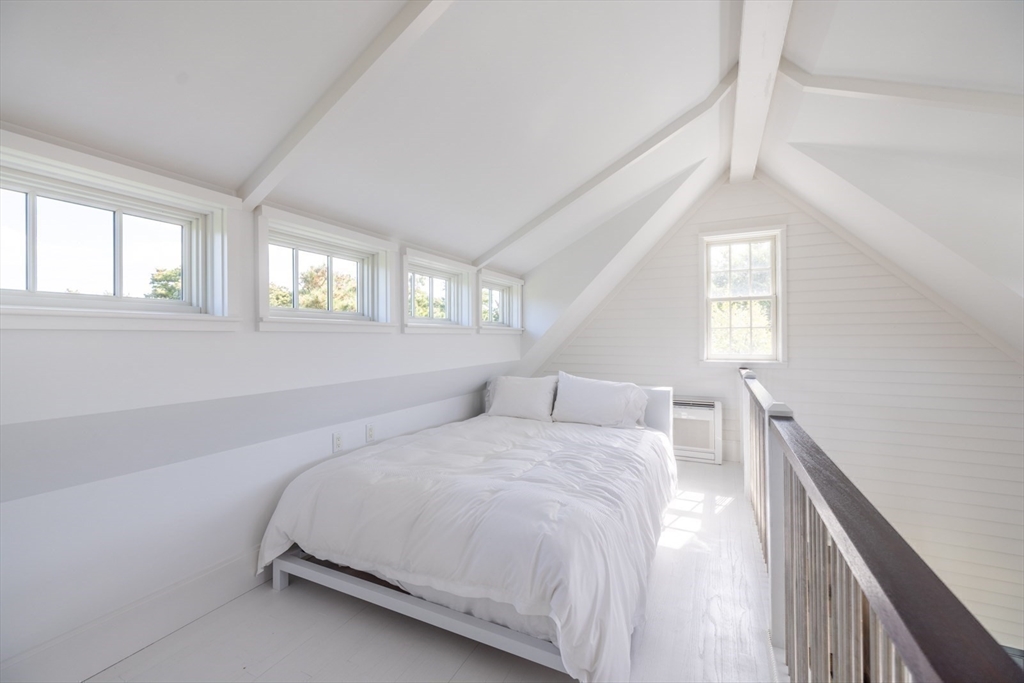 106 A Surfside Road, Unit EAST Nantucket, MA 02554 - Photo 40 of 42 a bedroom with a bed and a large window