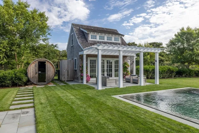 a view of a house with a yard and sitting area