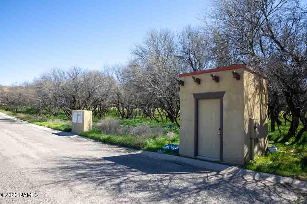 1097 Amber Way Camp Verde, AZ 86322 - Photo 20 of 22 a view of a house with a yard and large trees