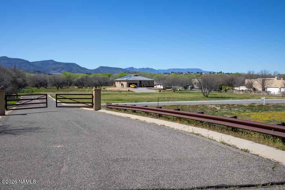 1097 Amber Way Camp Verde, AZ 86322 - Photo 2 of 22 a view of a street with a yard and a large tree