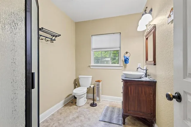 a bathroom with a window a sink and mirror