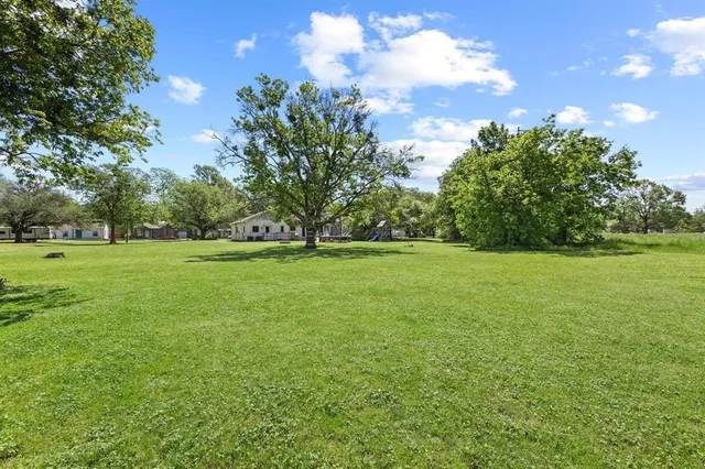 a backyard of a house with lots of green space