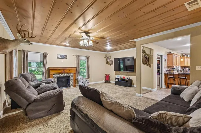 a living room with furniture a flat screen tv and a fireplace