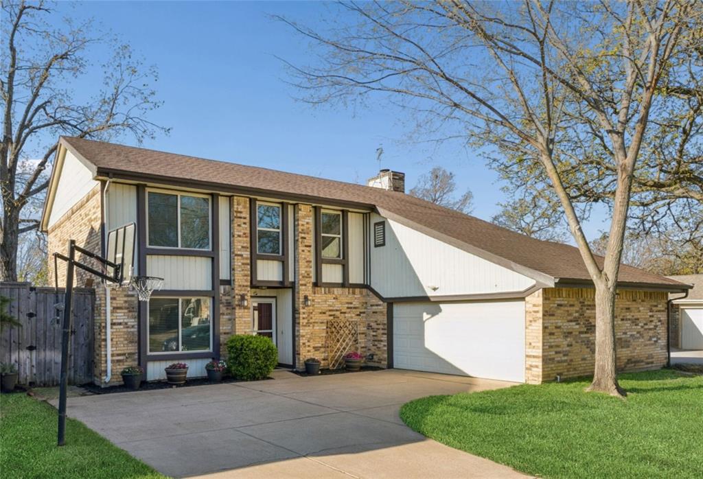 304 Lark Lane Euless, TX 76039 - Photo 2 of 32 a front view of a house with a garden and trees