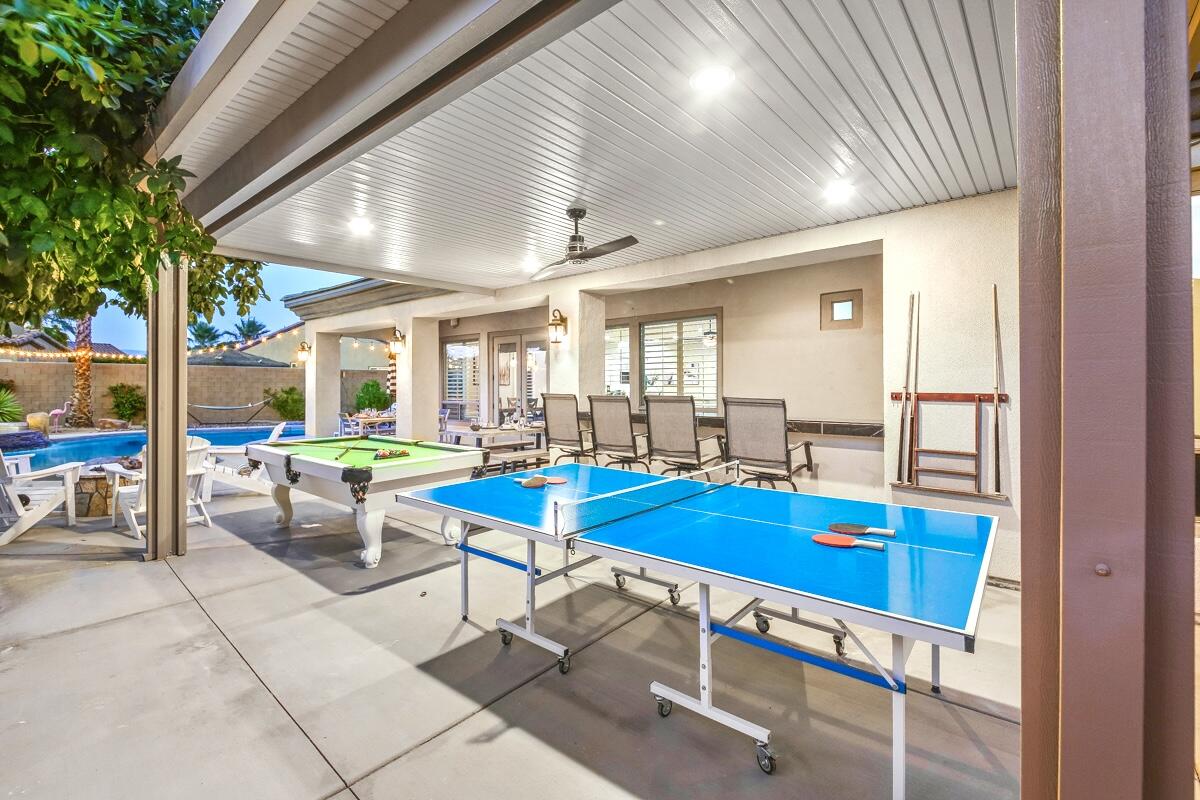 48713 Spring Rain Court Indio, CA 92201 - Photo 13 of 66 a view of a dining room with furniture and a table and chairs