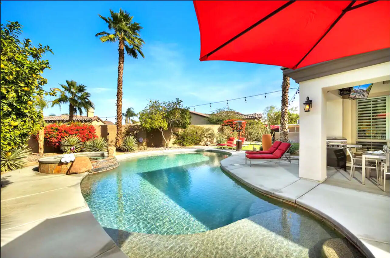 48713 Spring Rain Court Indio, CA 92201 - Photo 19 of 66 a view of a swimming pool with a lounge chairs