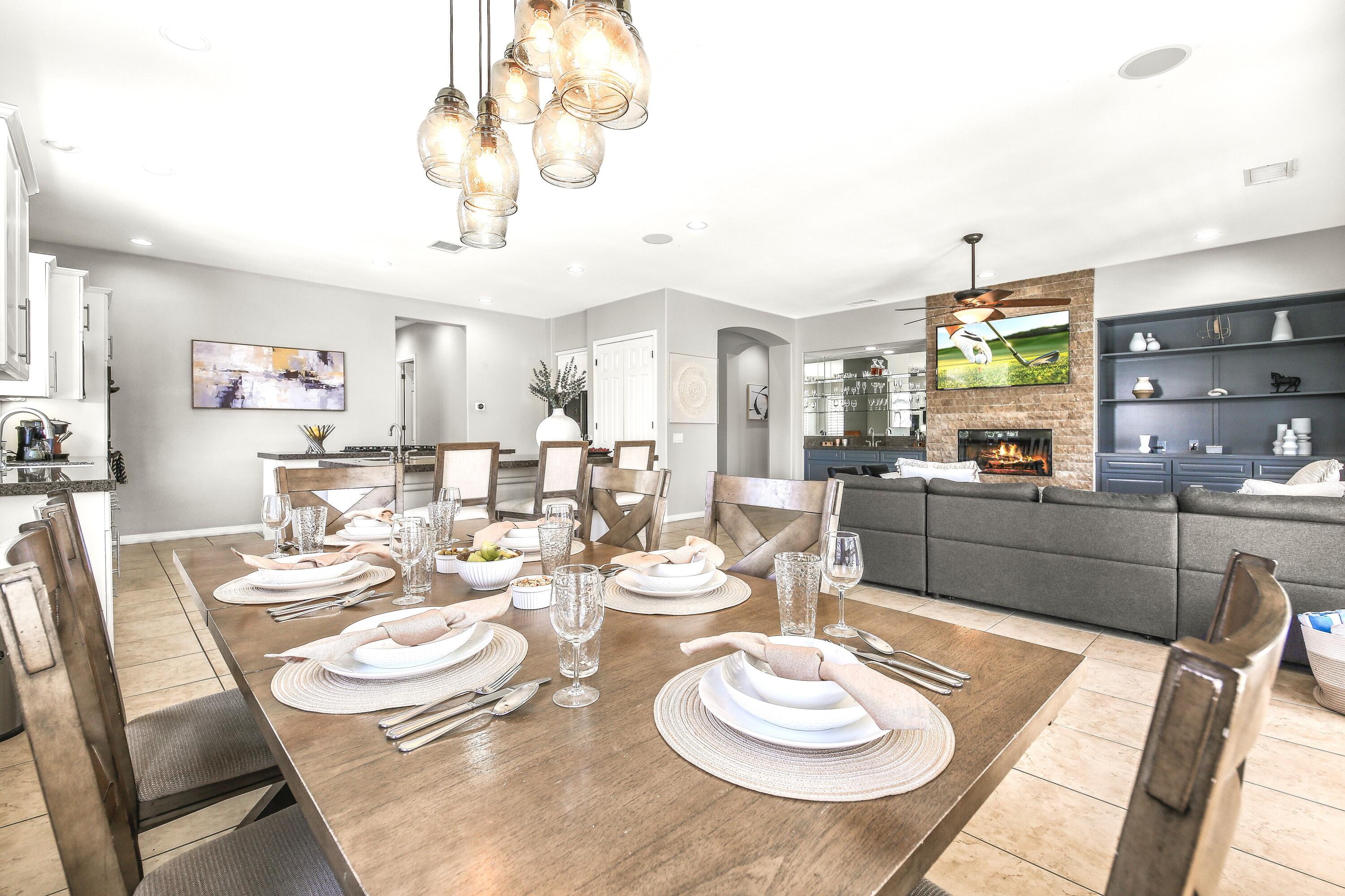 48713 Spring Rain Court Indio, CA 92201 - Photo 29 of 66 a dining room with wooden floor and kitchen view