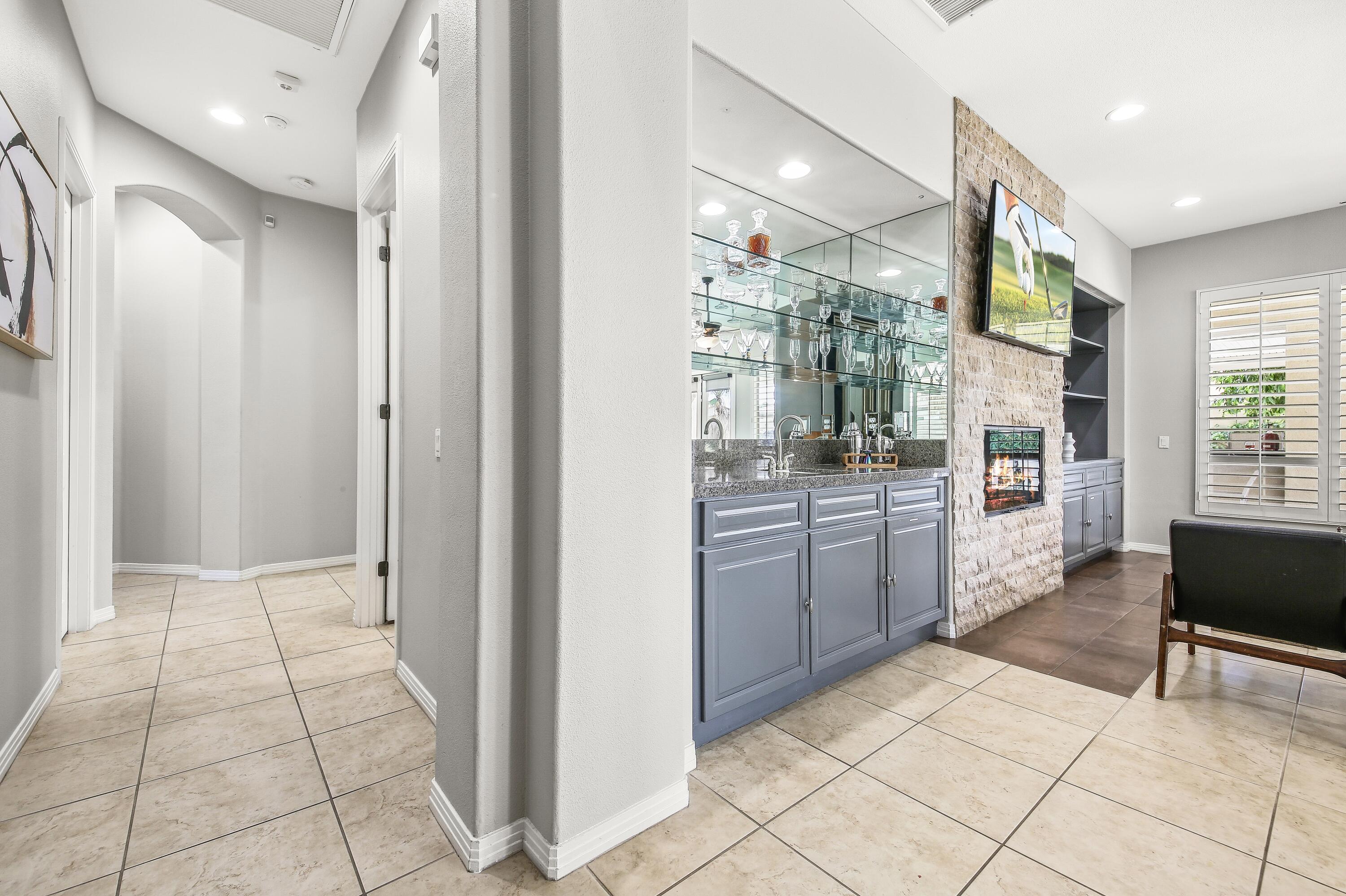 48713 Spring Rain Court Indio, CA 92201 - Photo 31 of 66 a kitchen with stainless steel appliances kitchen island granite countertop a refrigerator and a sink