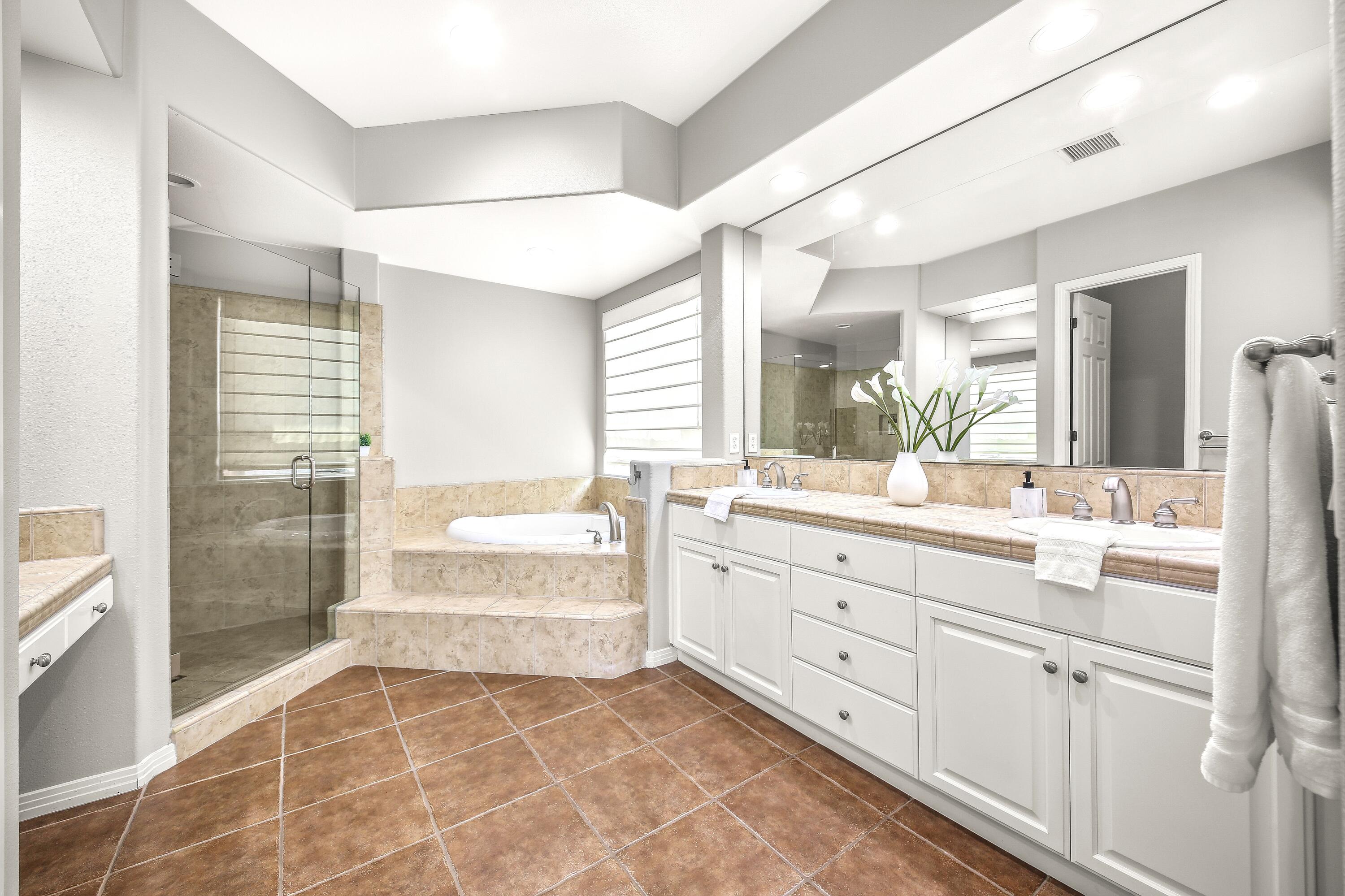 48713 Spring Rain Court Indio, CA 92201 - Photo 36 of 66 a large bathroom with a double vanity sink a mirror and a shower