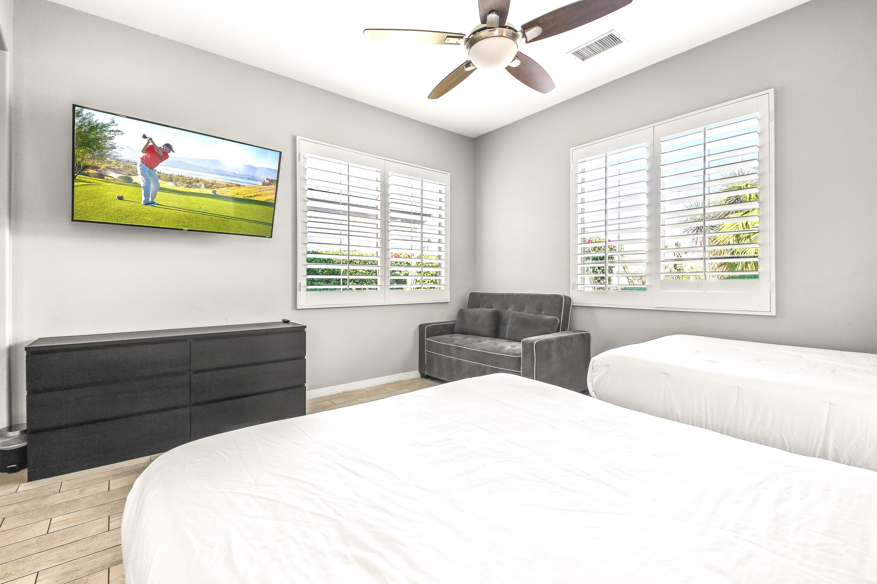 48713 Spring Rain Court Indio, CA 92201 - Photo 39 of 66 a bedroom with a bed a painting on the wall and a large window