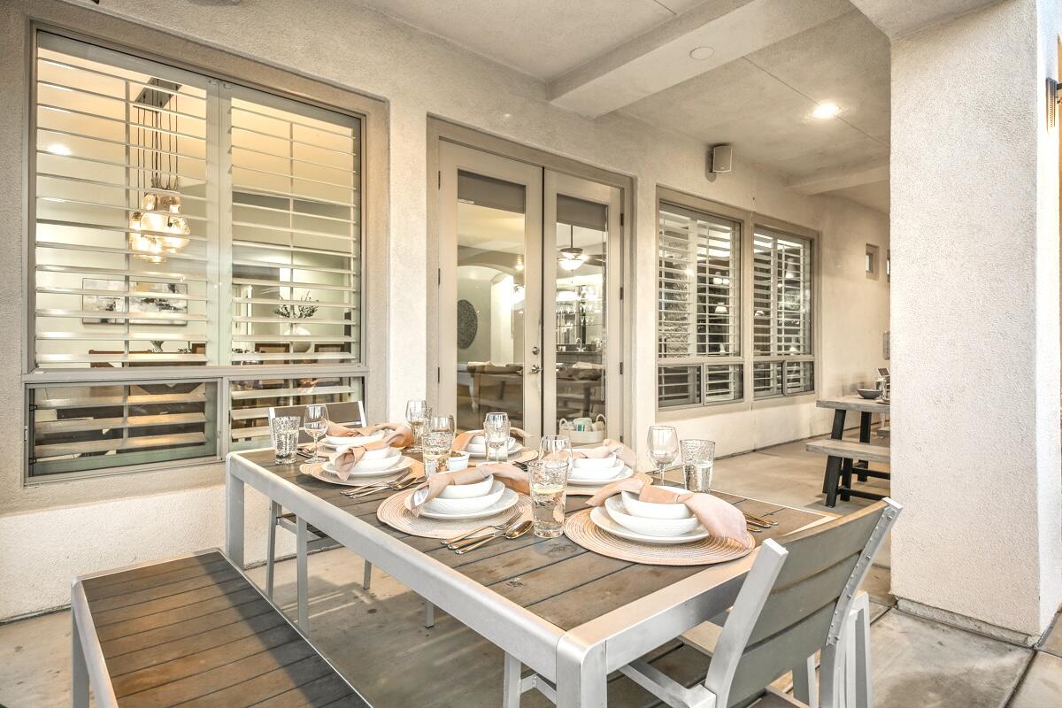 48713 Spring Rain Court Indio, CA 92201 - Photo 49 of 66 a dining room with wooden floor and large windows