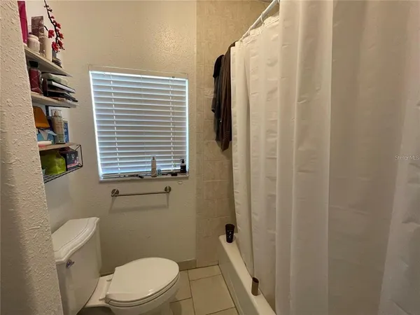 a bathroom with a toilet a sink and a window