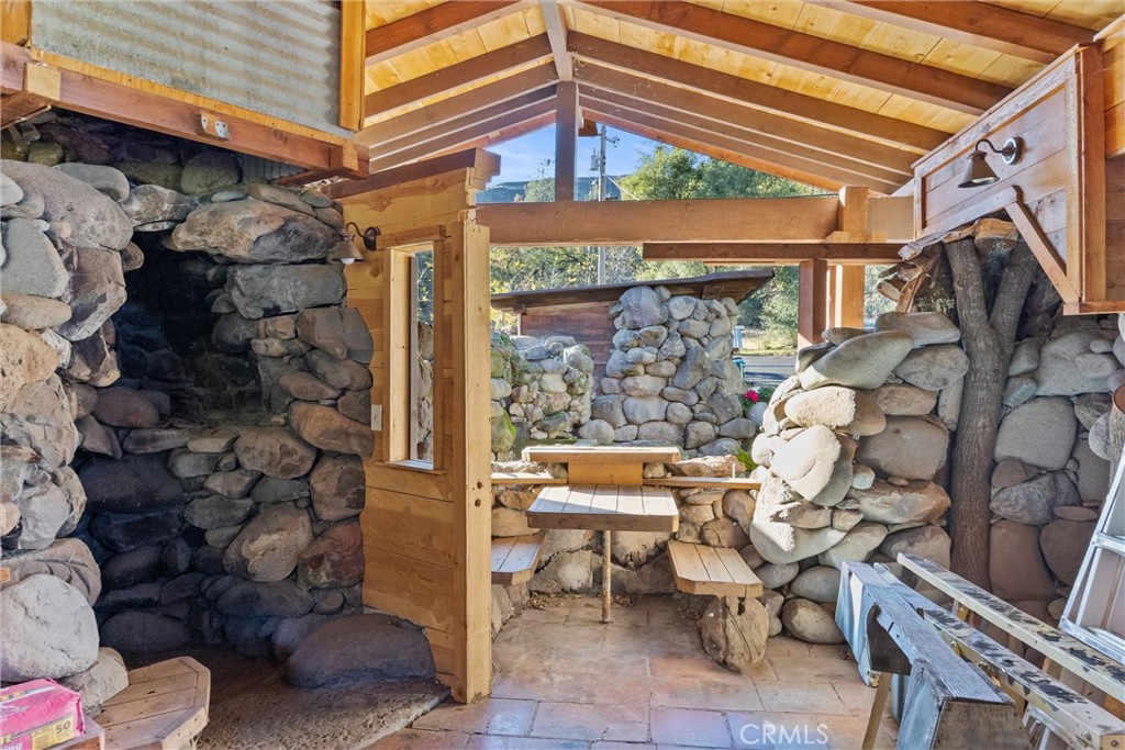 12656 Centerville Road Chico, CA 95928 - Photo 30 of 46 Cabin Interior with Rock Wood Stove Area and Built-In Dining Area