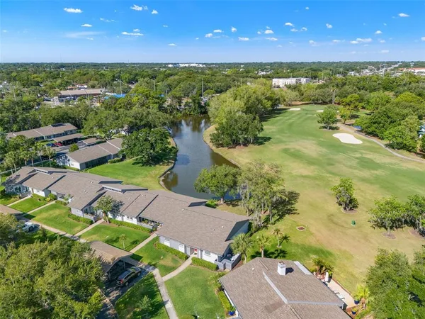an aerial view of a house with a yard
