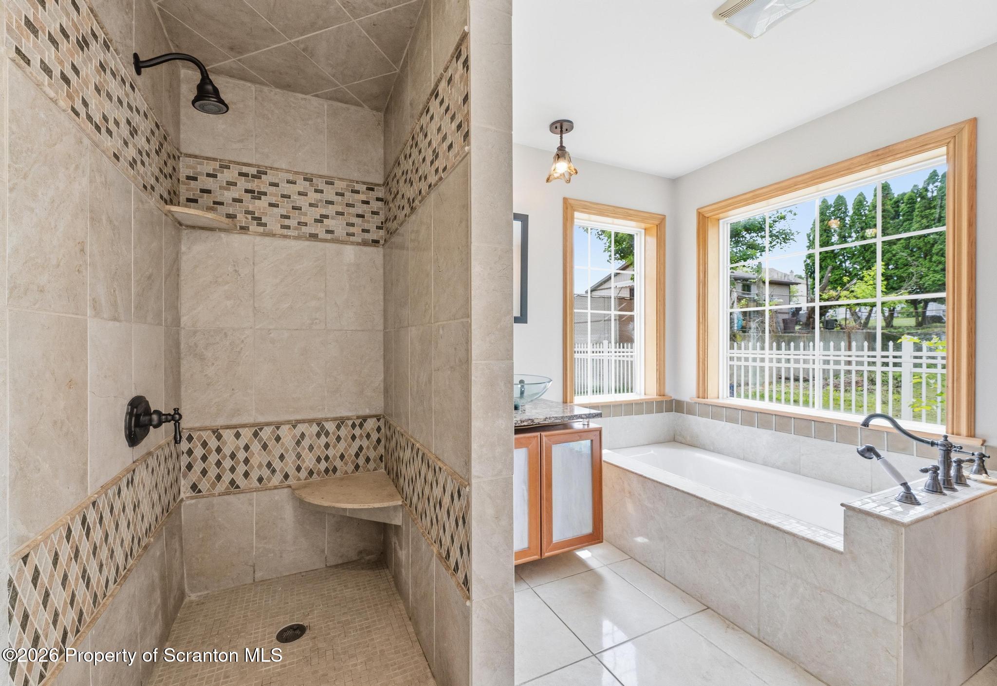 116 Forge Street Old Forge, PA 18518 - Photo 27 of 49 a spacious bathroom with a bathtub and window