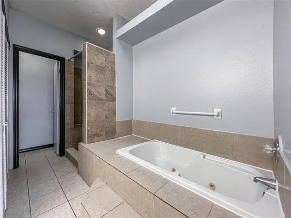 a spacious bathroom with a bathtub and a shower