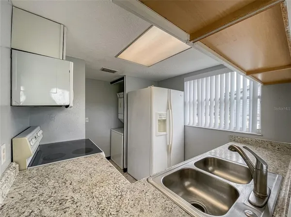 a kitchen with a sink and a refrigerator