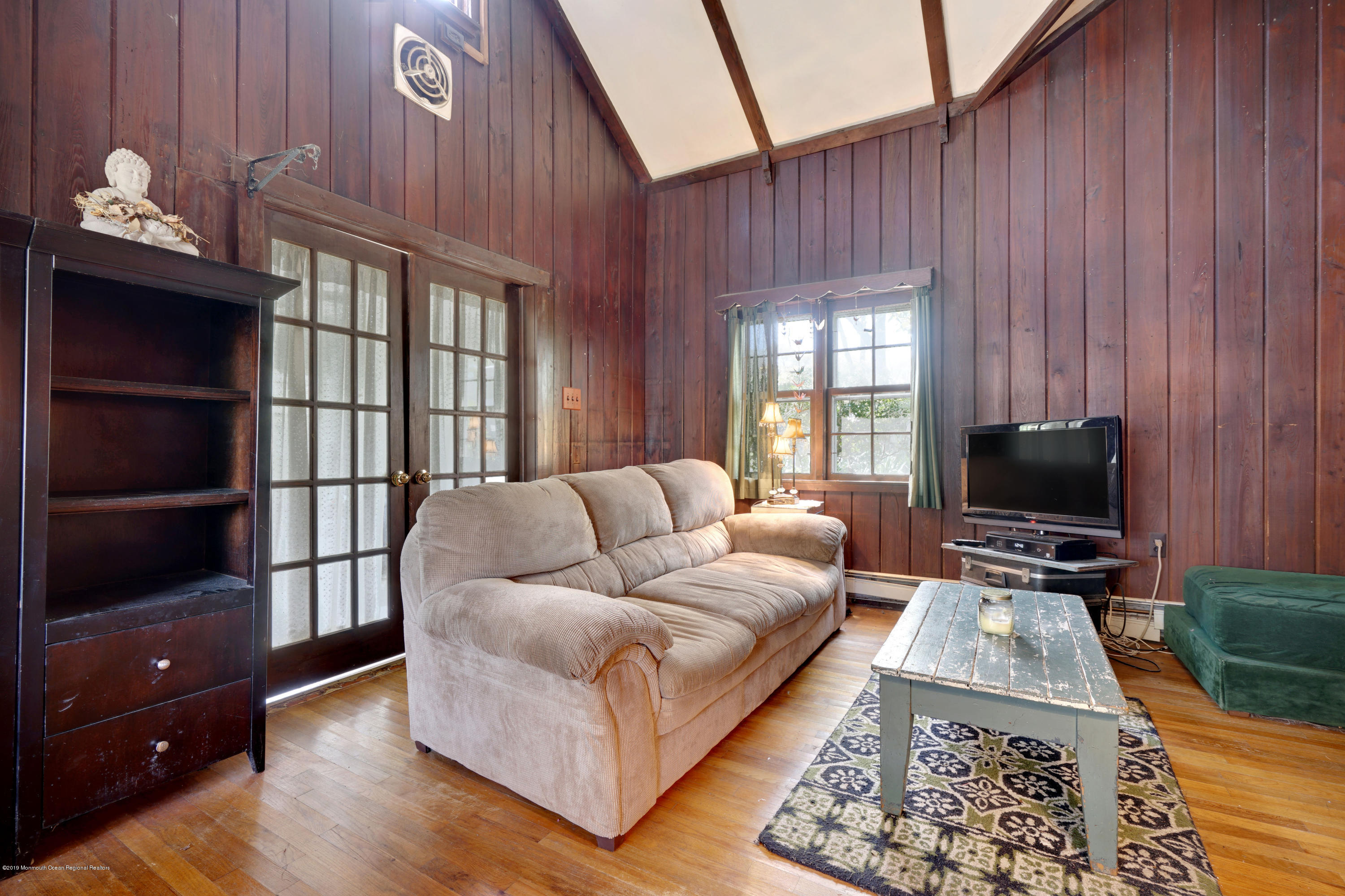 100 Breton Road Brick, NJ 08723 - Photo 11 of 37 a living room with furniture and a flat screen tv