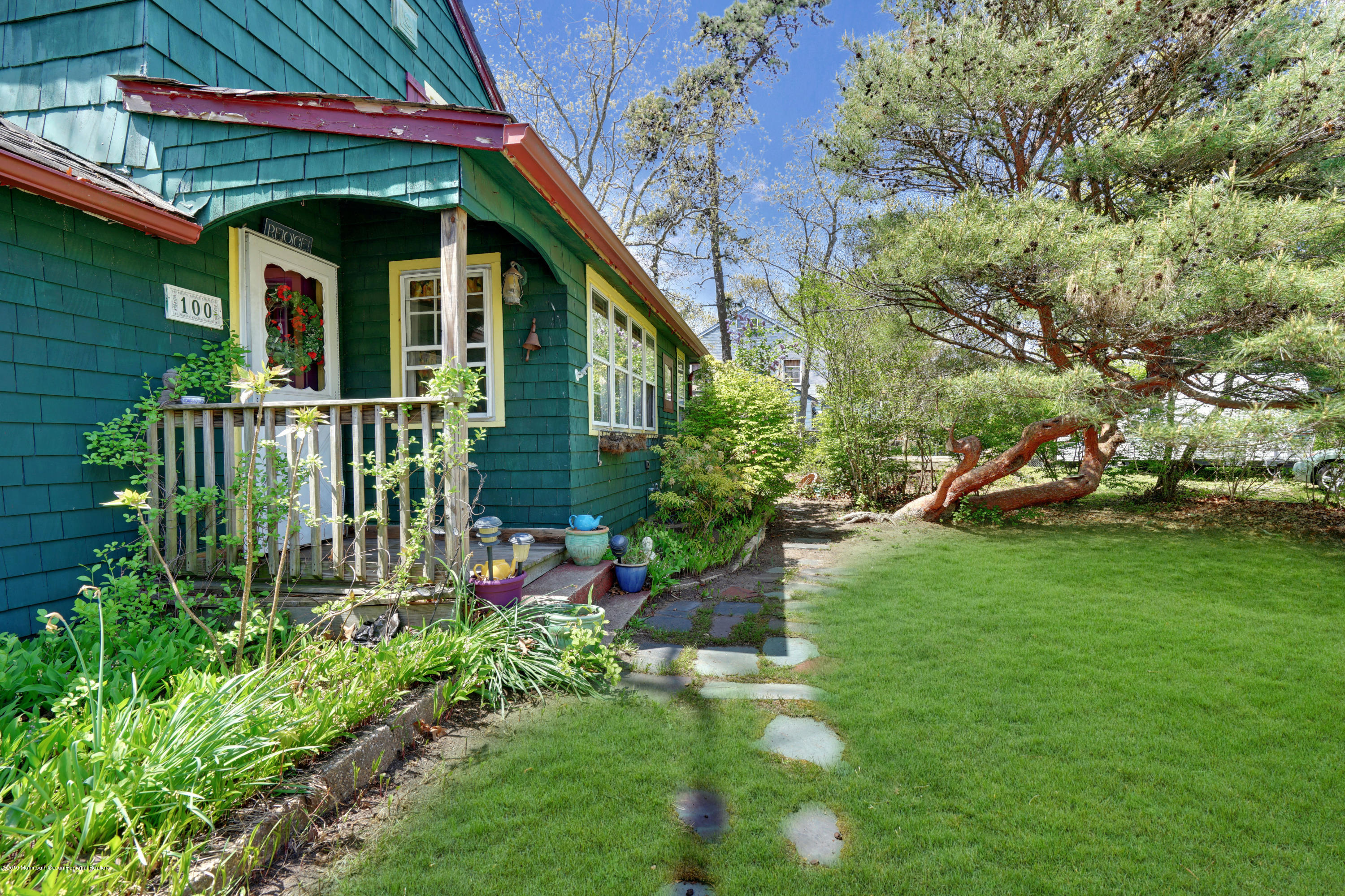 100 Breton Road Brick, NJ 08723 - Photo 2 of 37 a view of a small house with a small yard plants and large tree