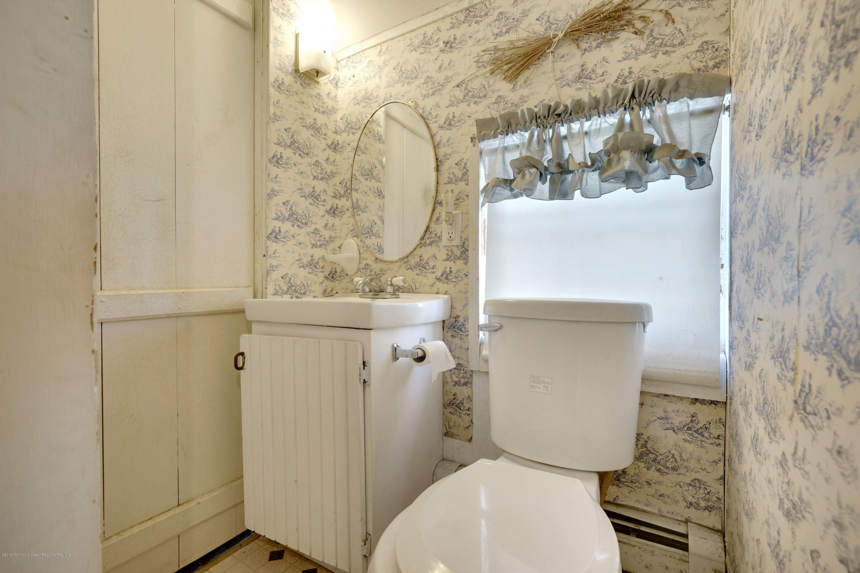 100 Breton Road Brick, NJ 08723 - Photo 30 of 37 a white toilet sitting next to a shower curtain