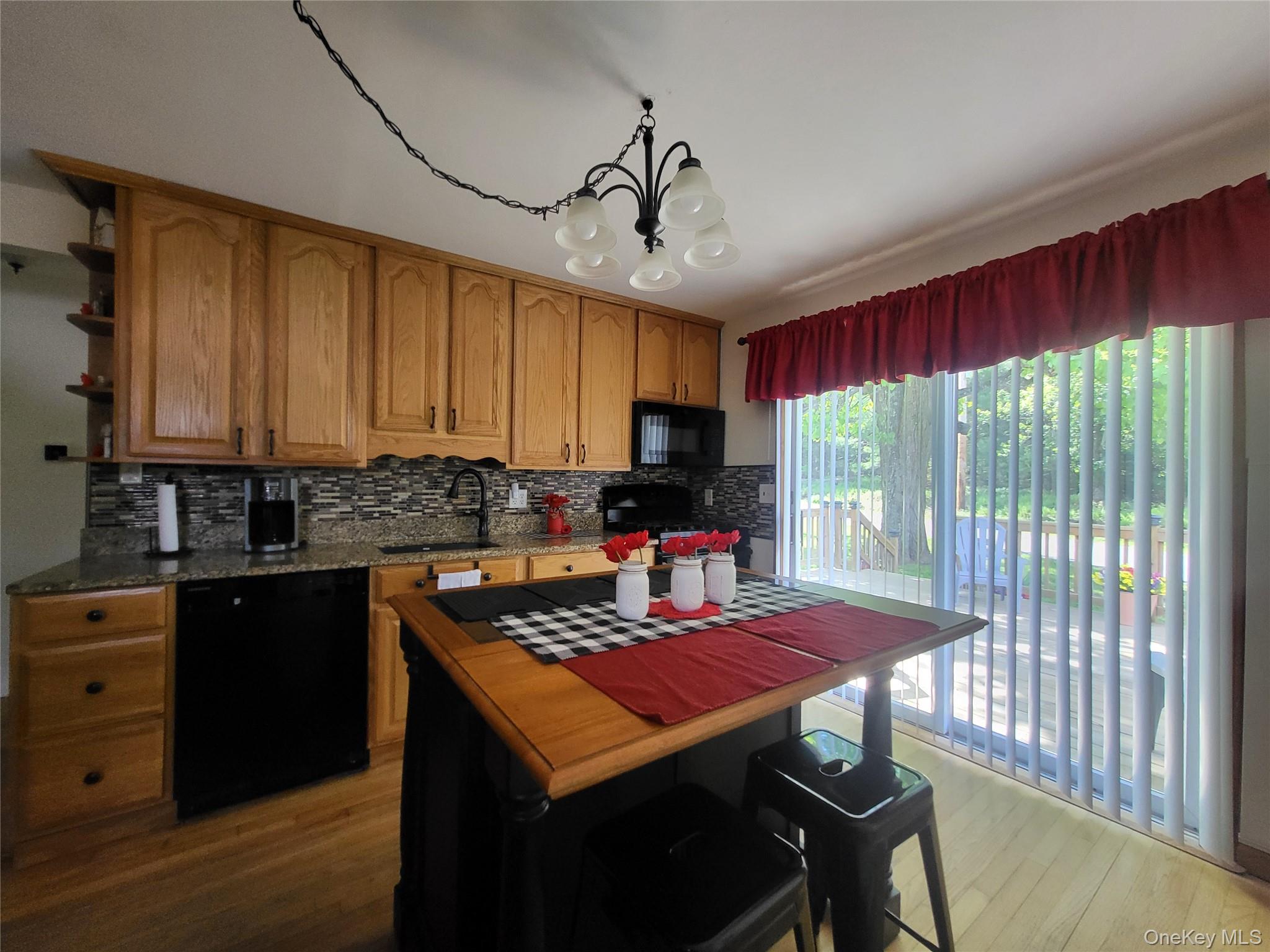 286 Dingle Daisy Road Monticello, NY 12701 - Photo 13 of 35 a kitchen with a stove a sink dishwasher and a microwave oven with cabinets
