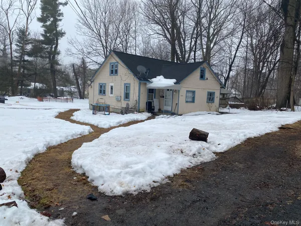a view of a house with snow on the road