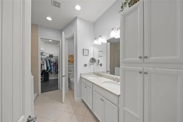 a bathroom with a double vanity sink a and a mirror