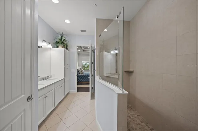 a bathroom with a glass shower door and a sink