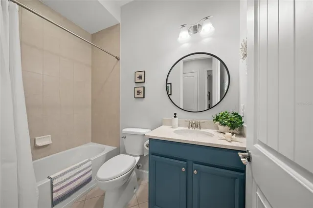 a bathroom with a sink mirror vanity and toilet