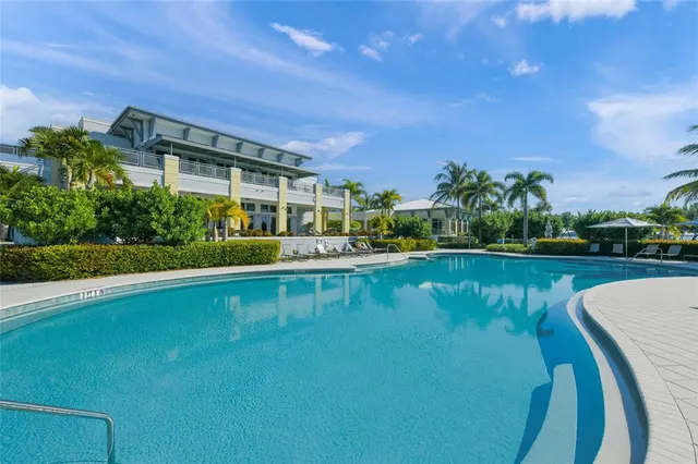 a view of a house with a yard and palm trees