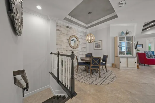 a view of a dining room with furniture and chandelier