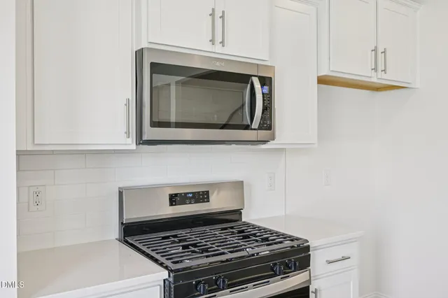 a view of a kitchen with wooden floor