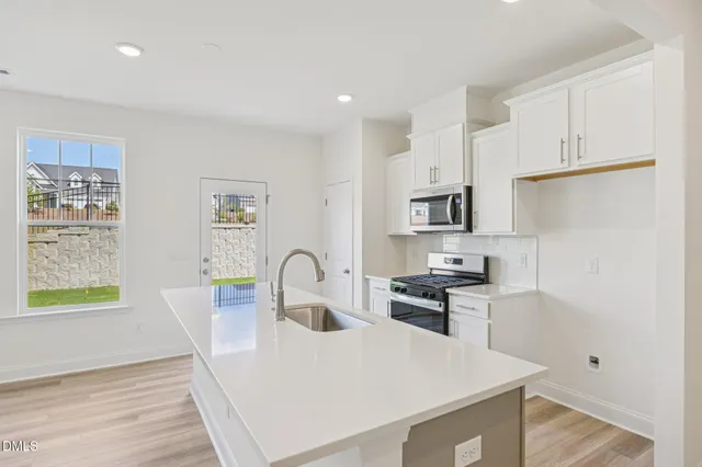 a kitchen with a sink stove and cabinets