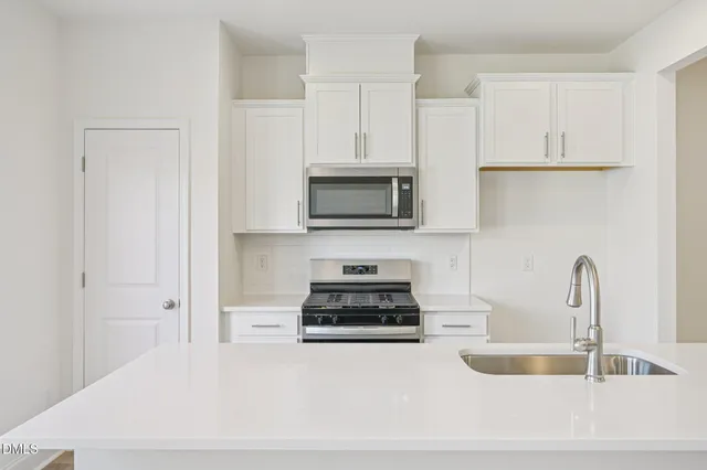 a stove top oven sitting inside of a kitchen