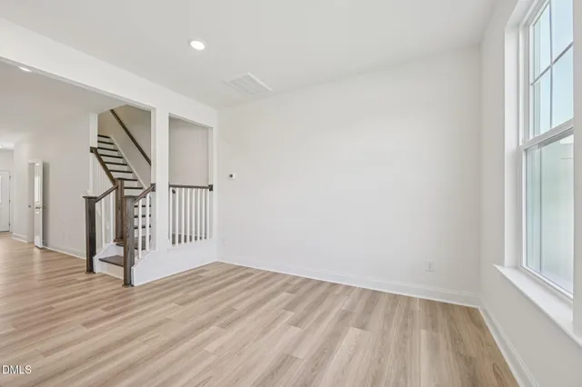 a kitchen with white cabinets and appliances
