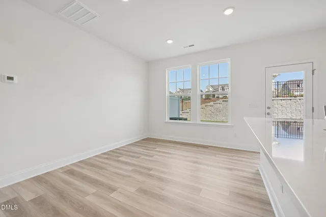 a kitchen with a sink a stove and white cabinets